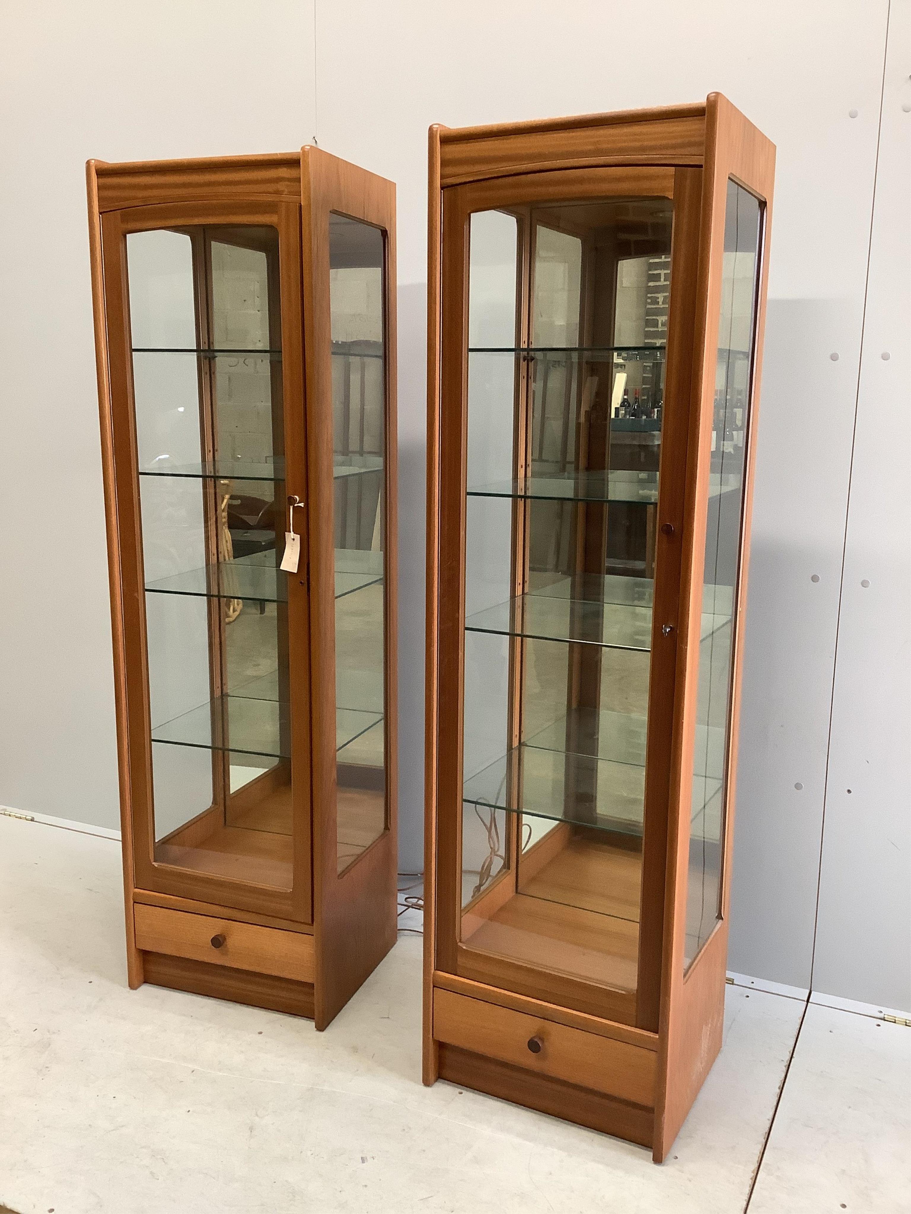 A pair of Parker Knoll teak display cabinets, width 46cm, depth 38cm, height 165cm. Condition - good